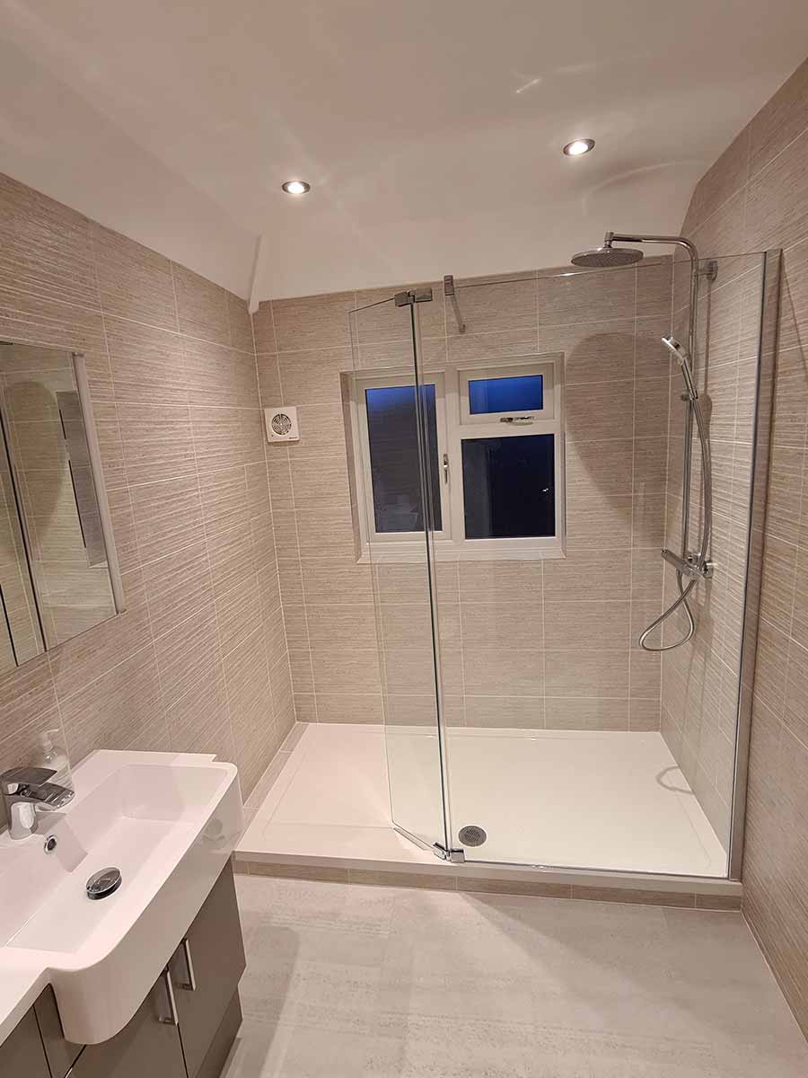 Walk-in shower with a rainfall head and textured tiles