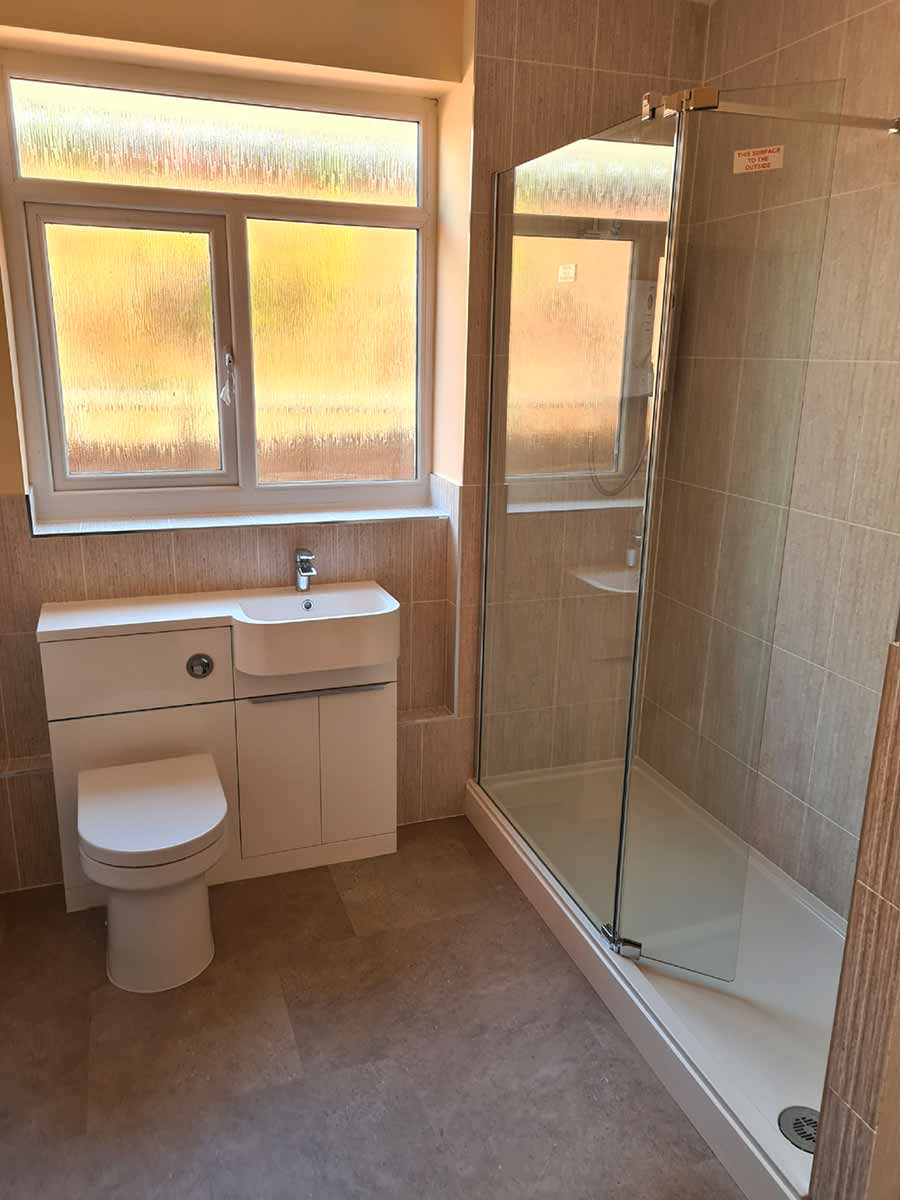 Shower room with a frameless screen and fitted vanity