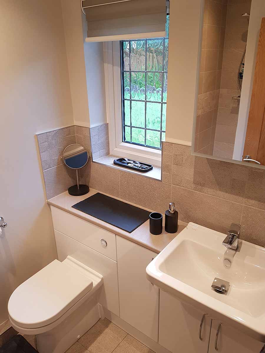 Cloakroom with a fitted vanity unit