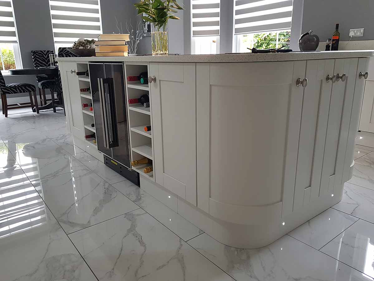 Curved Shaker island with a built-in wine rack
