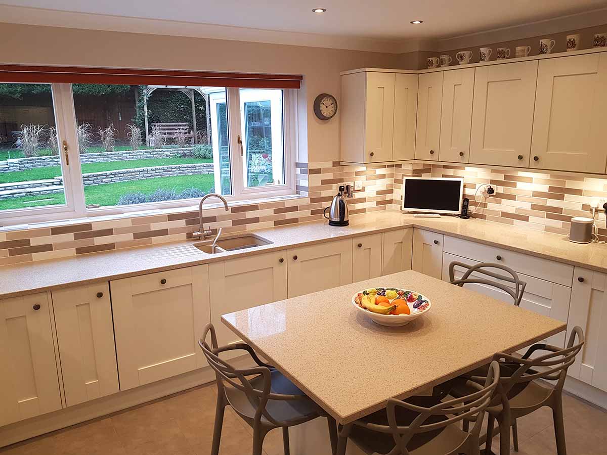 Oyster Shaker kitchen with a breakfast table looking onto the garden