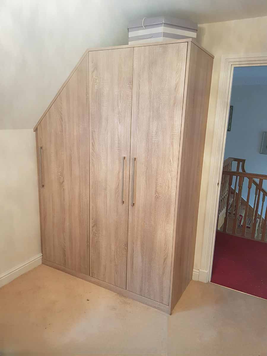 Fitted wardrobe built into a sloping ceiling