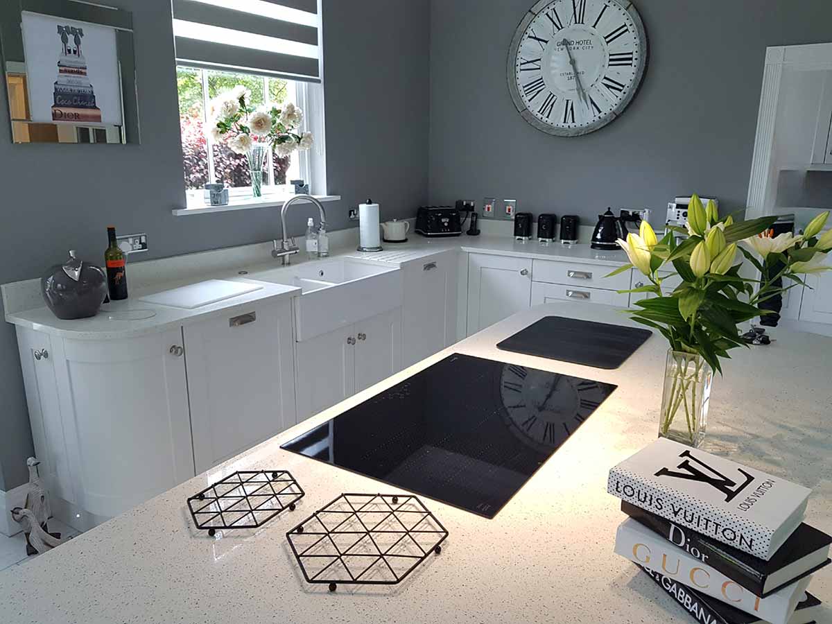 Painted Shaker kitchen with a Belfast sink and induction hob